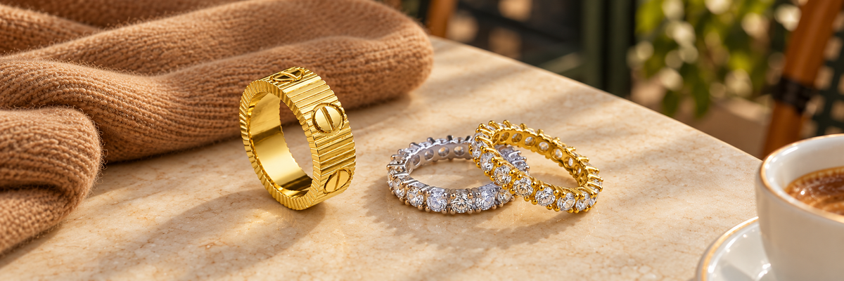 Poshewix Rings collection styled on a warm café table with camel knit